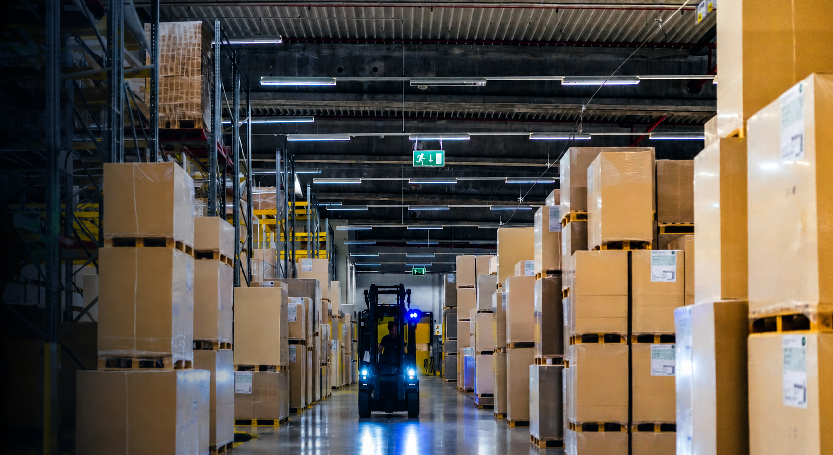 Warehouse distribution center with forklift moving pallets
